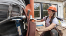 Photo of female apprentice working at construction site