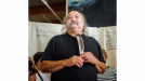 Photo of Alan Syliboy holding a feather