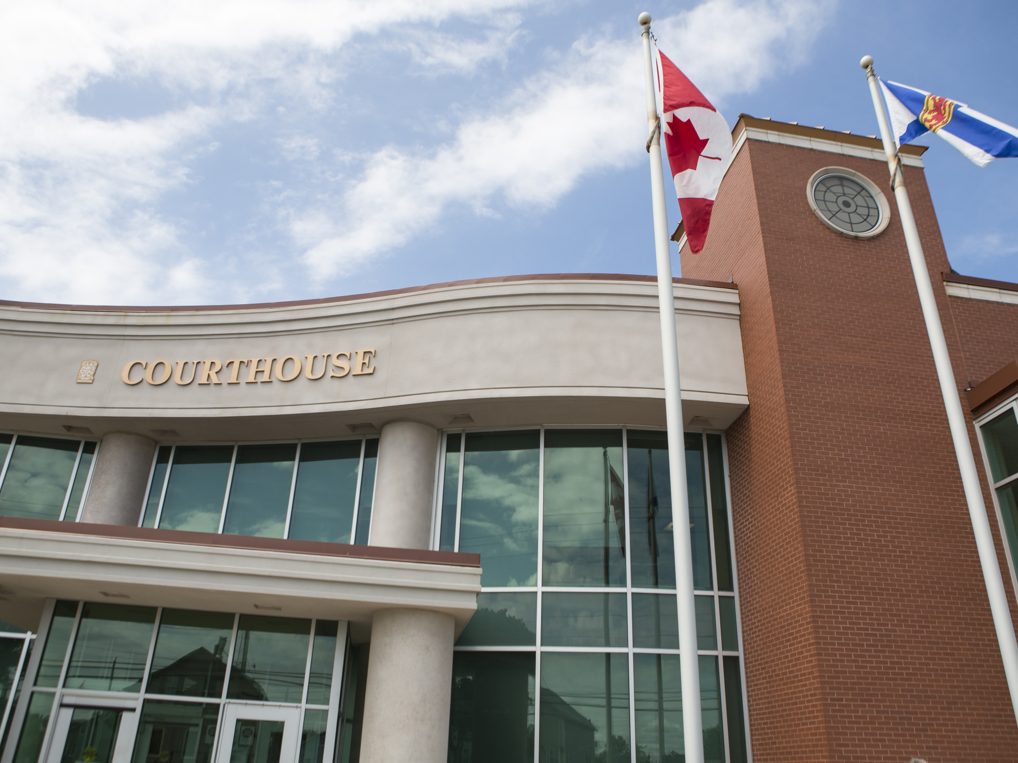 Photo showing the exterior of a Nova Scotia courthouse with a Canadian flag flying