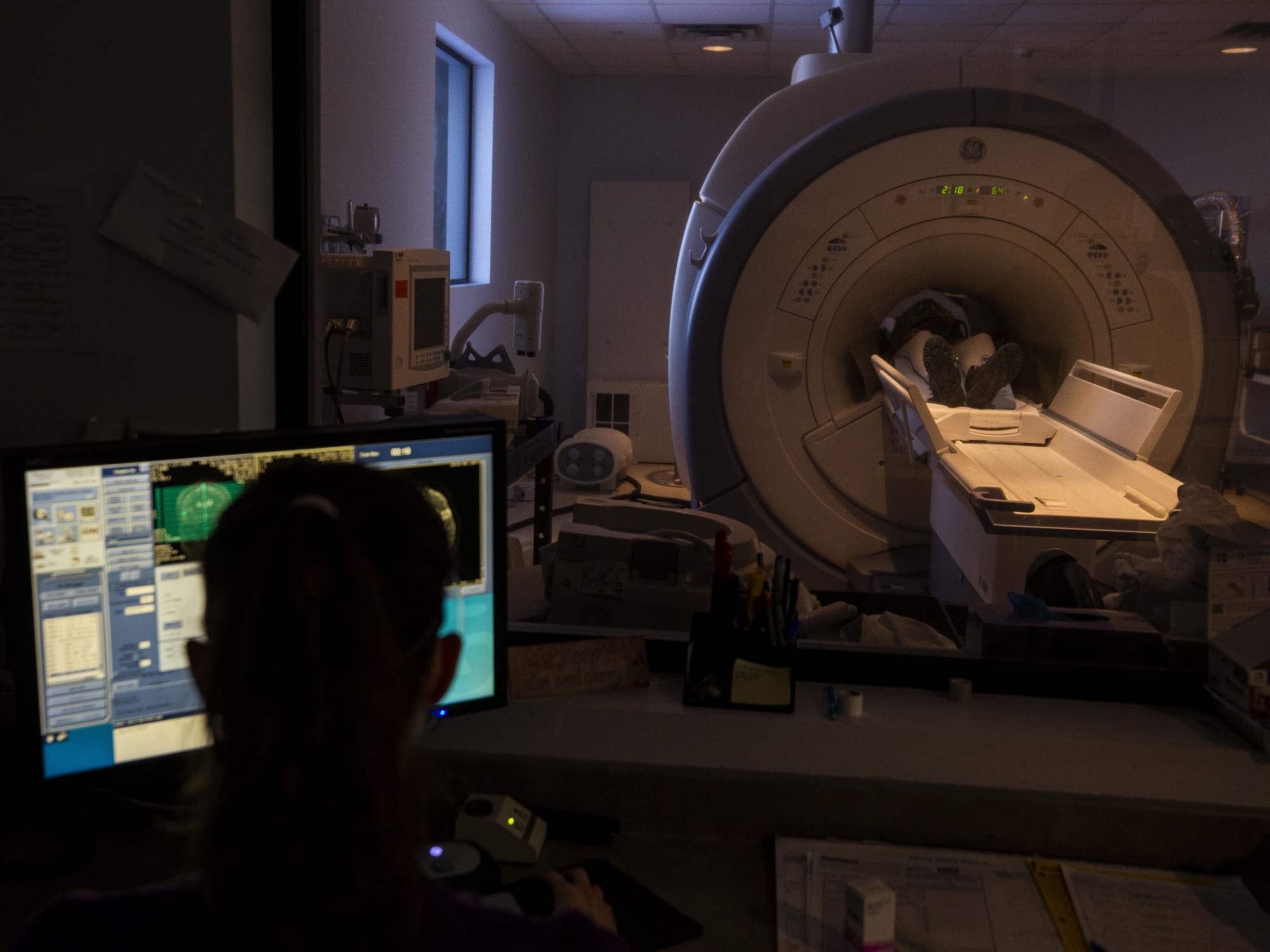 Photo showing a healthcare worker performing a CT scan on a patient