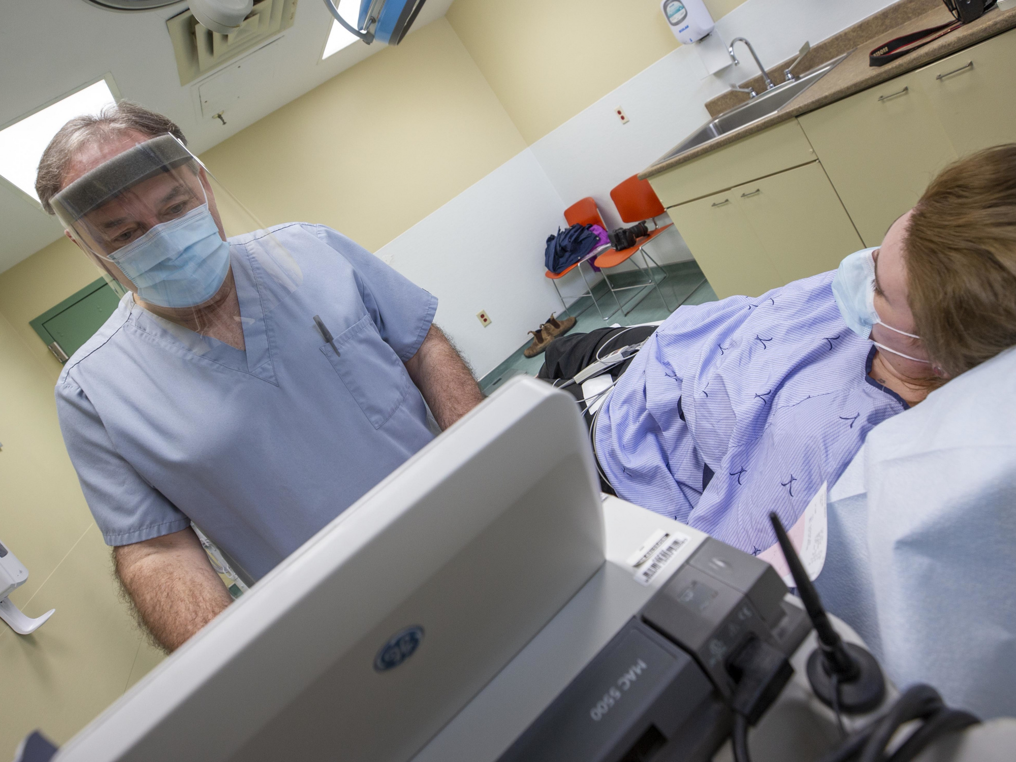 Photo showing an ultrasound technician with a patient