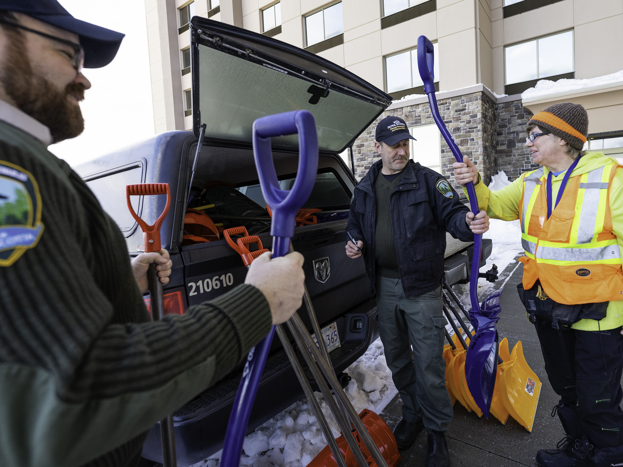 Department of Natural Resources and Renewables staff hand out snow shovels.