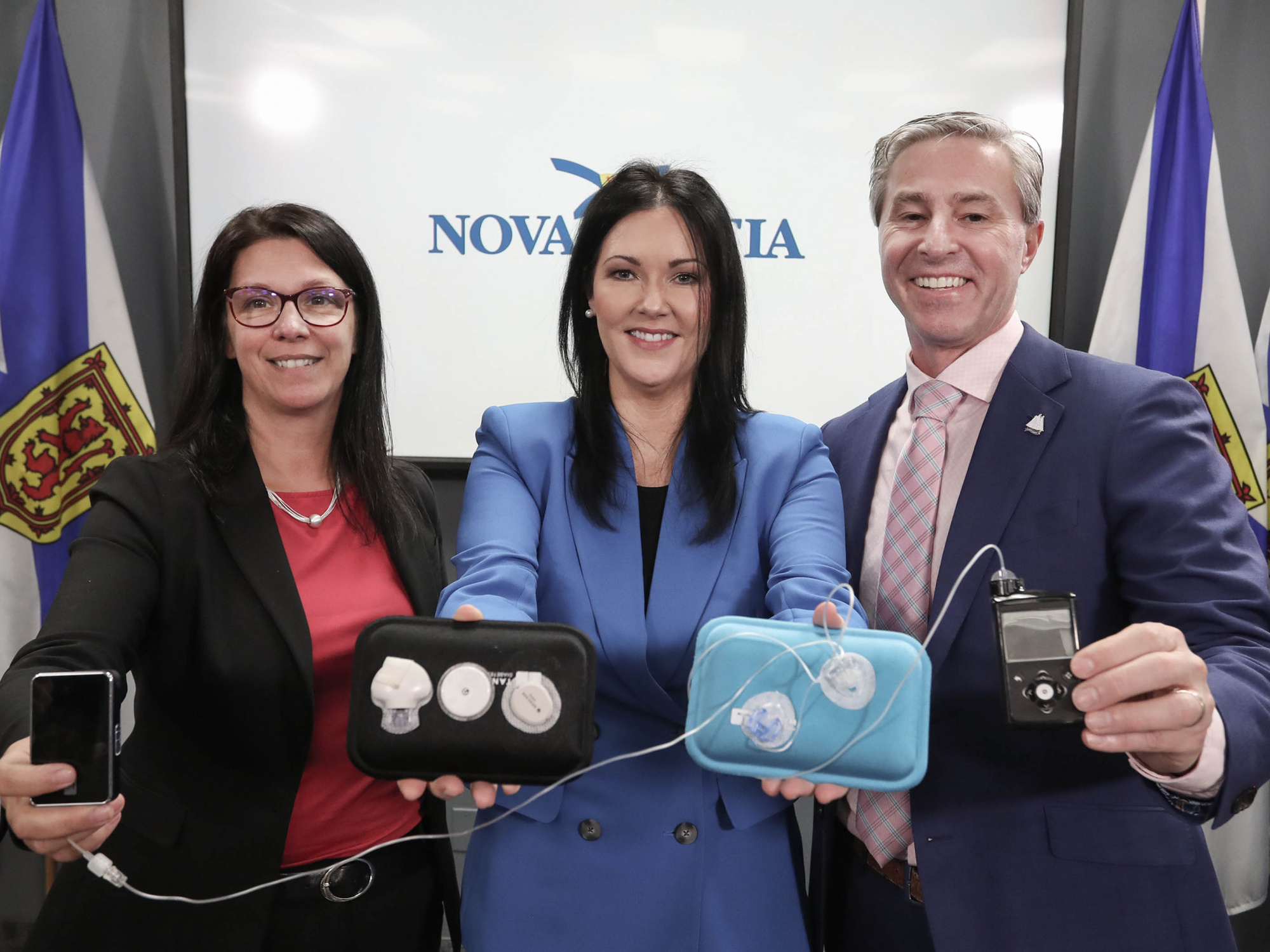 Photo of Health and Wellness Minister Michelle Thompson; Maria Campbell, Director of Government Affairs and Advocacy with Diabetes Canada; and Premier Tim Houston with glucose monitors