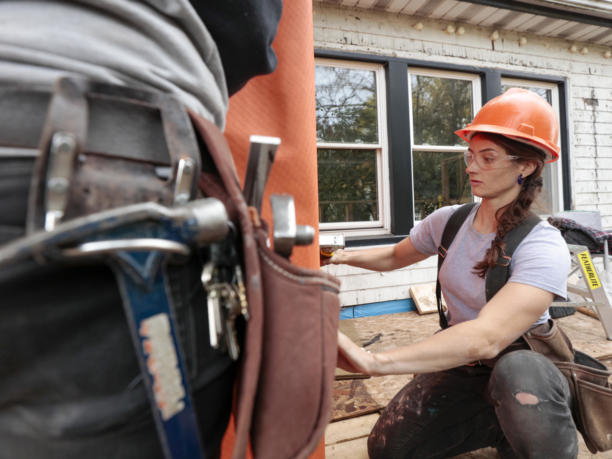 Photo of female apprentice working at construction site