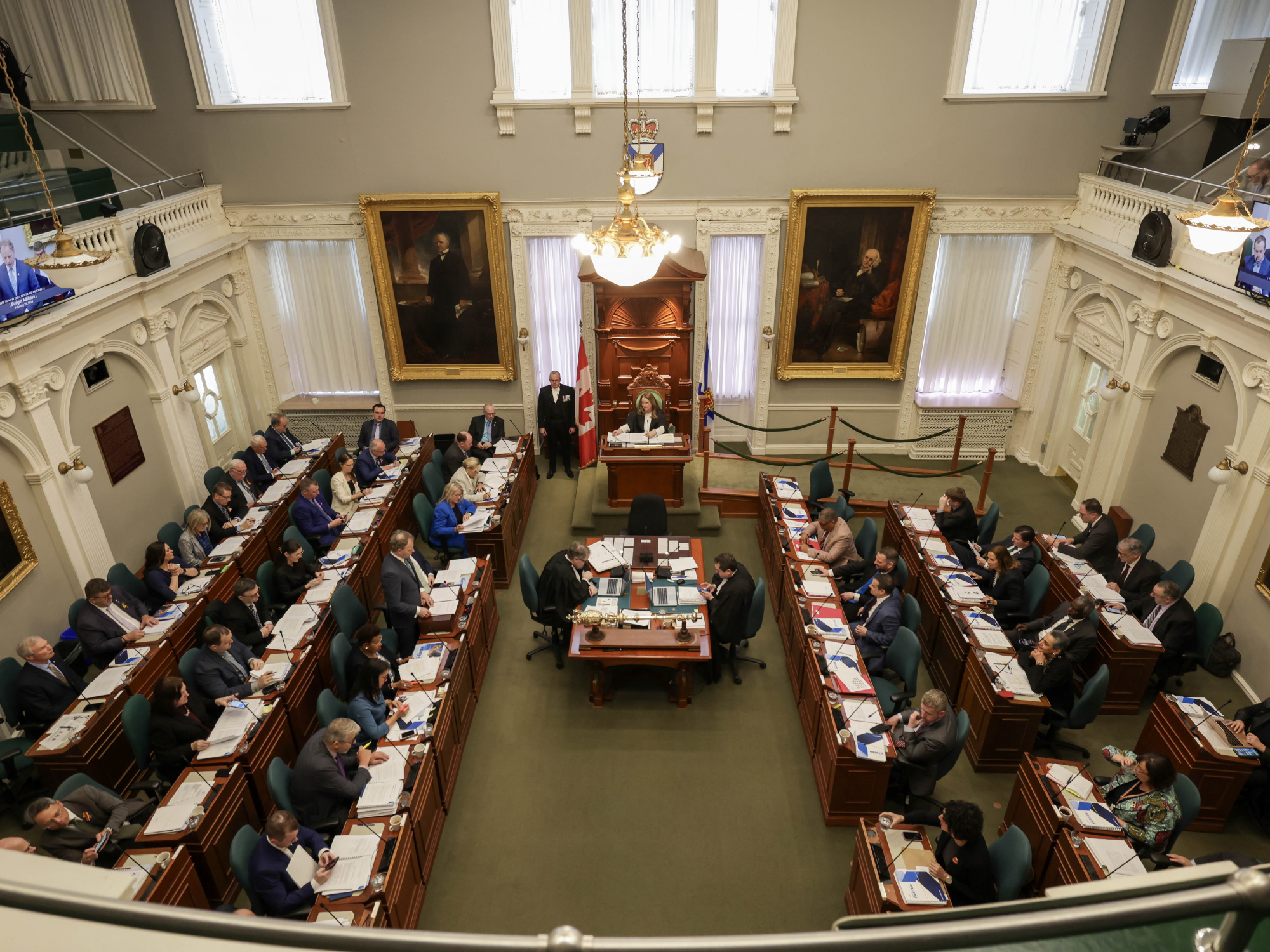 Wide shot of the legislative chamber with Finance and Treasury Board Minister Allan MacMaster delivering his budget address