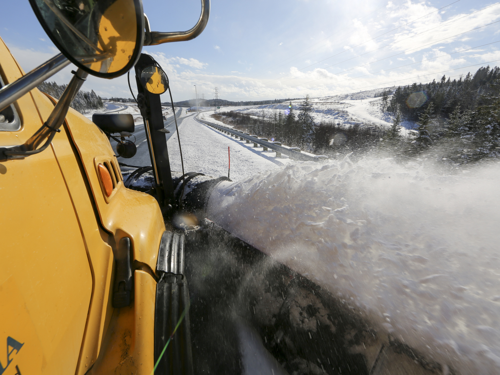 Photo of snowplow and snow spraying up