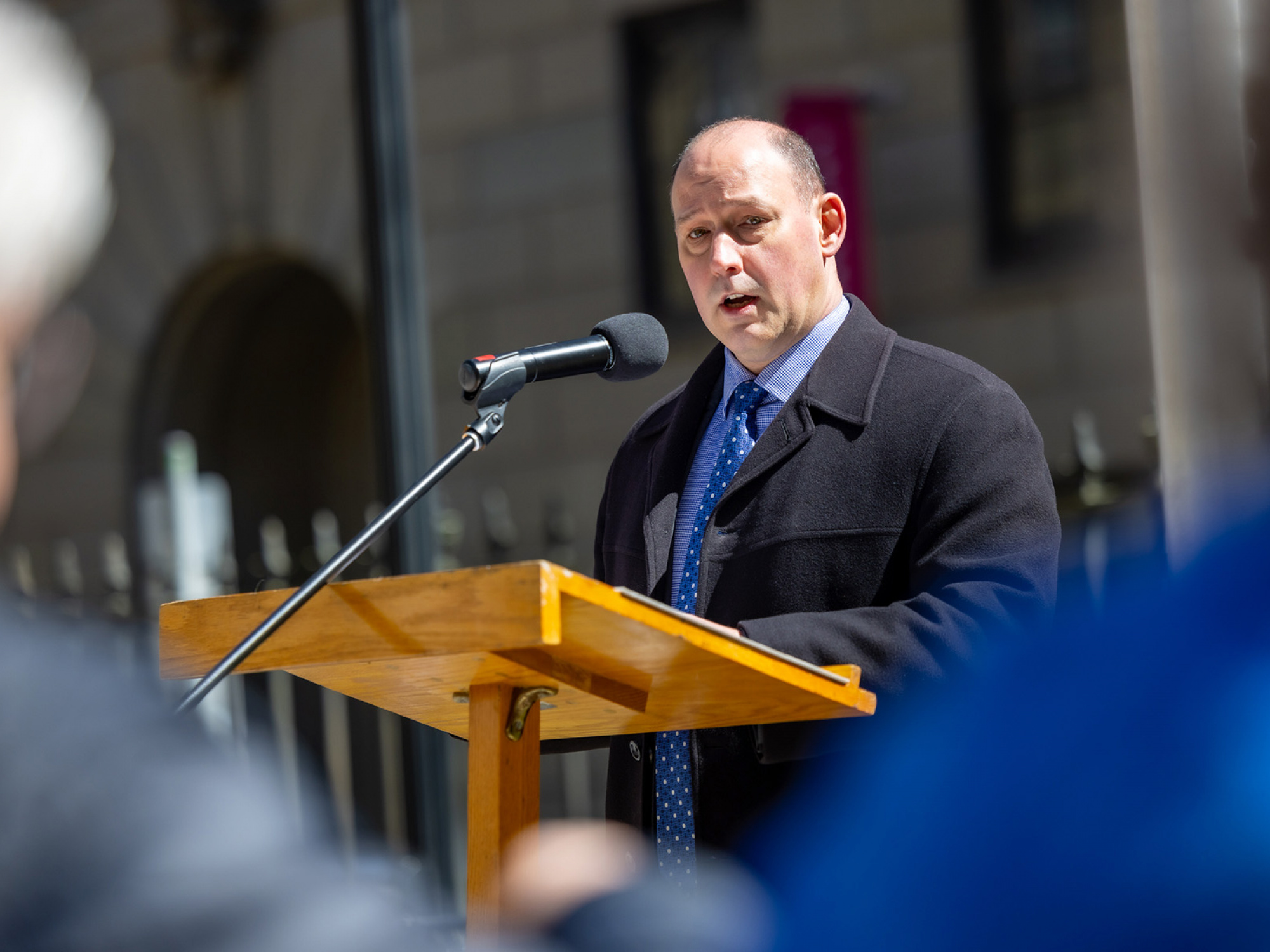 Honourable Minister Timothy Halman addresses the crowd who gathered at Province House for the National Day of Mourning. Minister Halman spoke on behalf of the Province of Nova Scotia and Minister of Labour, Skills and Immigration, Jill Balser, asking people to pause, reflect and remember those who have died at work or because of their work.