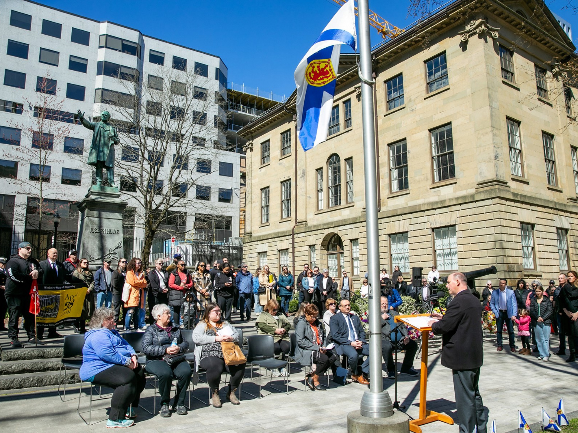 Photo of Minister Halman speaking at Day of Mourning ceremony outside Province House