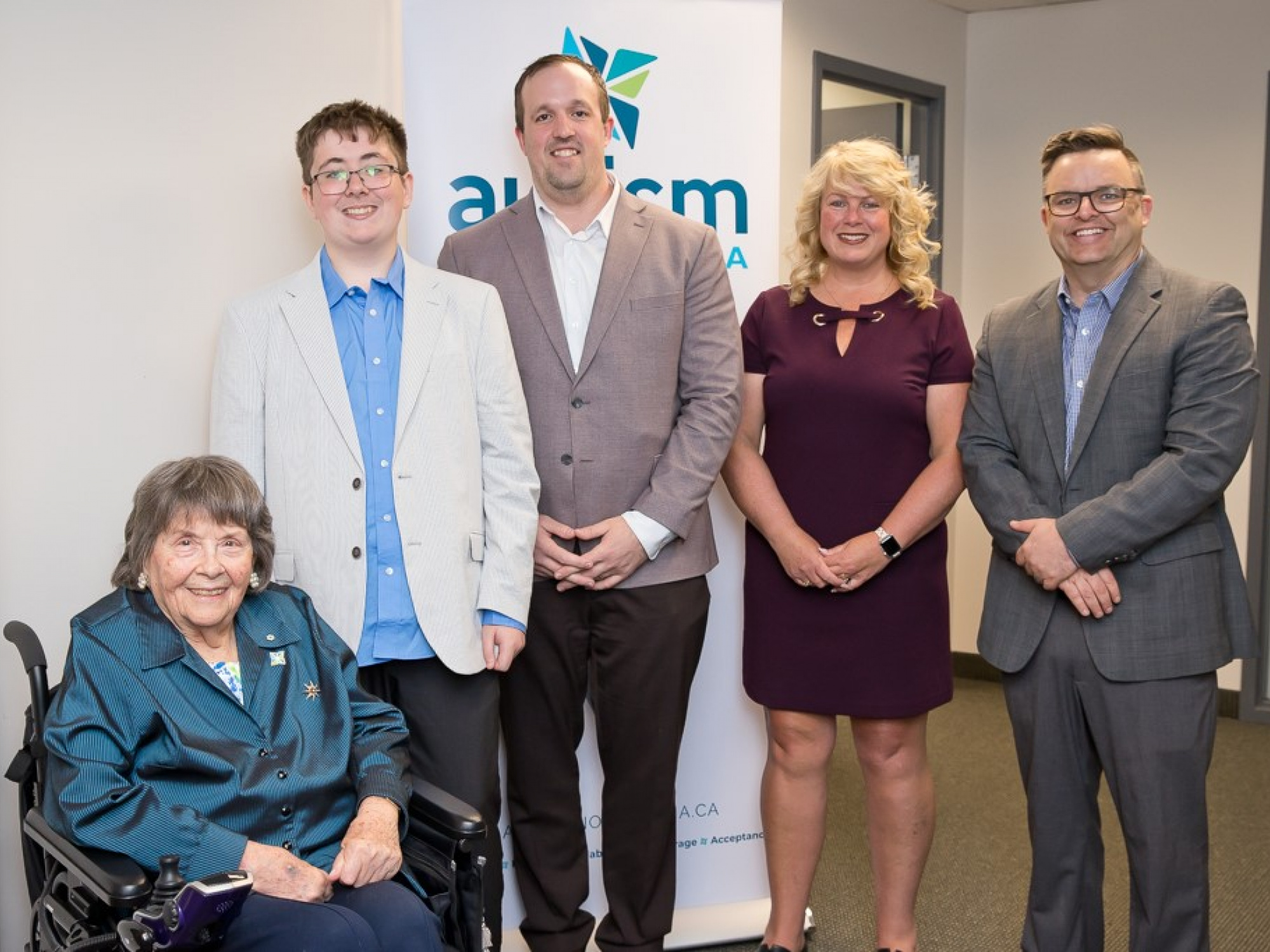 Photo of Joan Craig, founder of Autism Nova Scotia; Ethan Rekunyk, who has autism and is an advocate; Brian Comer, Minister of Addictions and Mental Health; Cynthia Carroll, Executive Director, Autism Nova Scotia; and Brendan Maguire, Minister of Community Services