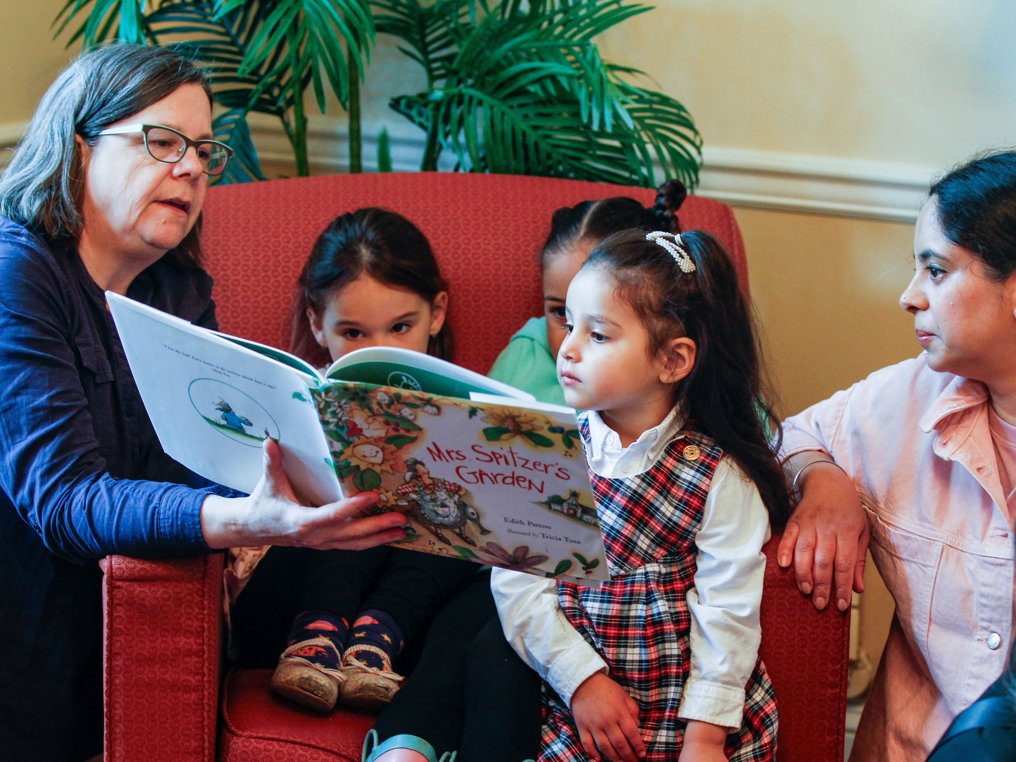 Photo of early childhood educator reading to children