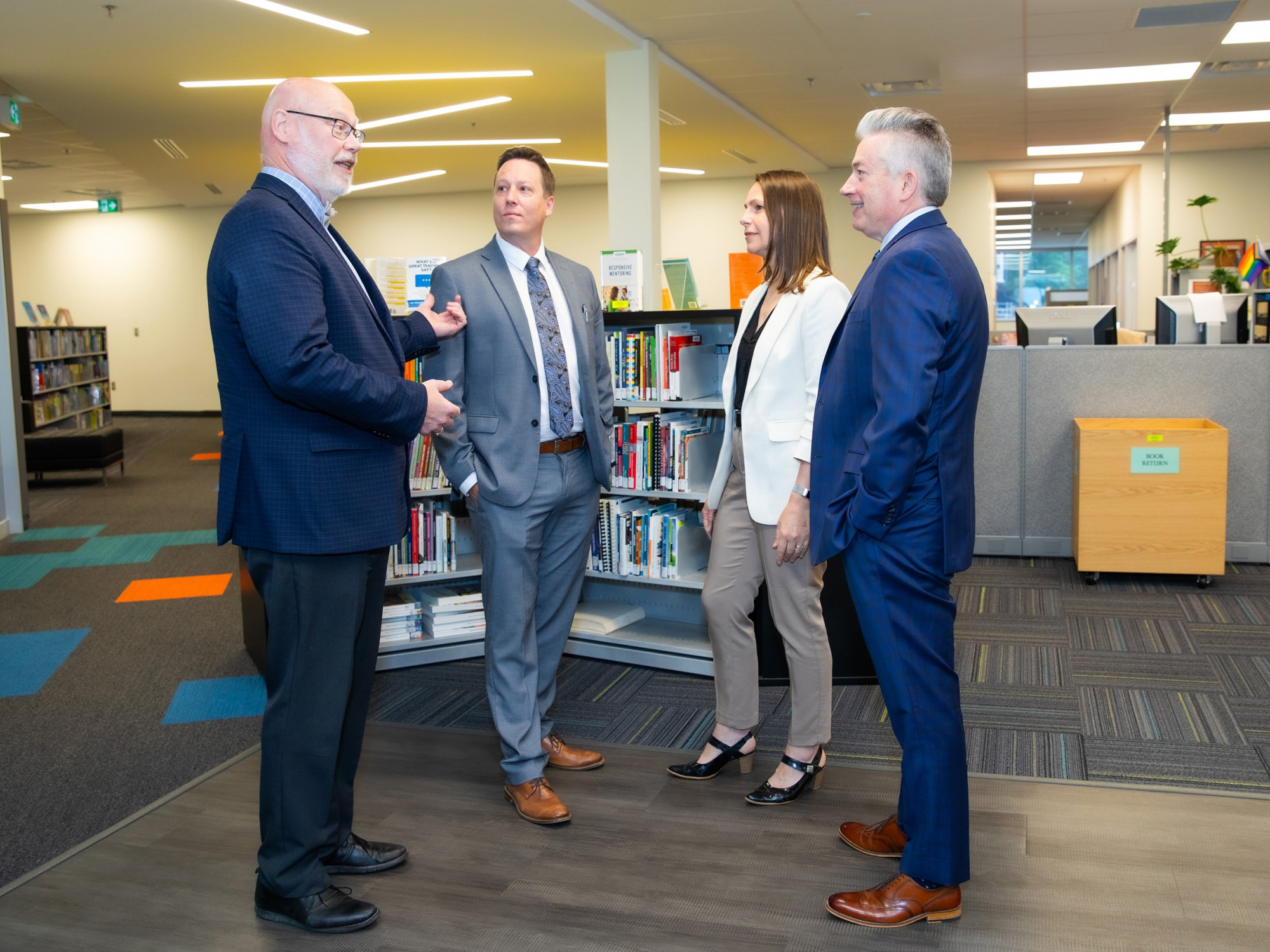 Photo of Education and Early Childhood Development Minister Becky Druhan with three officials