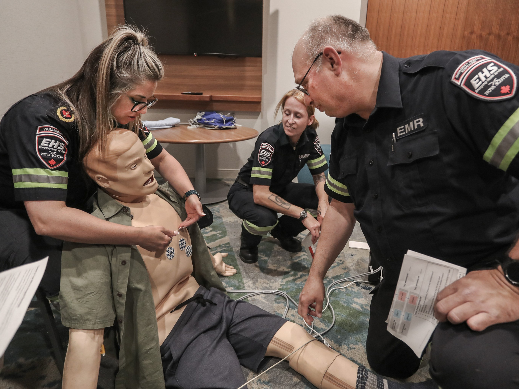 Emergency Health Services paramedics Samantha Lamplugh, left, and Kim Smith, centre, instruct Vince McNamara during orientation training in the Emergency Medical Responder Program this spring.