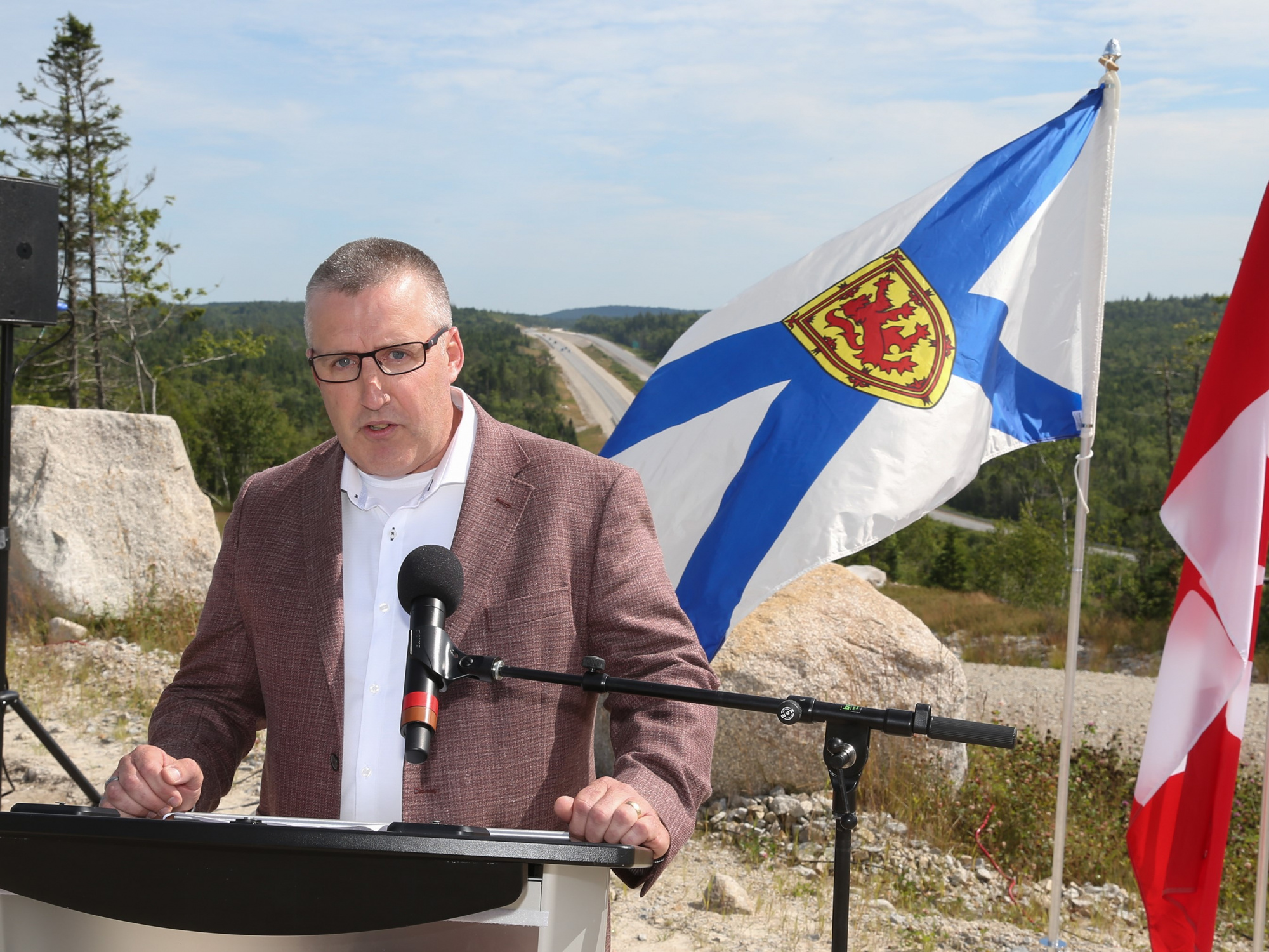 Photo of Mark Underhill of Dexter Construction at a podium