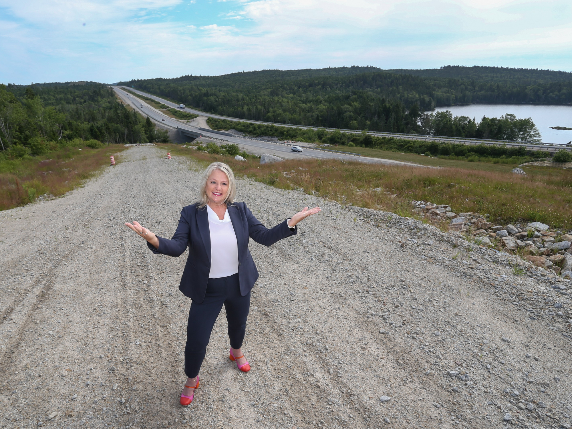 Photo of Public Works Minister Kim Masland outside with Highway 103 in the background