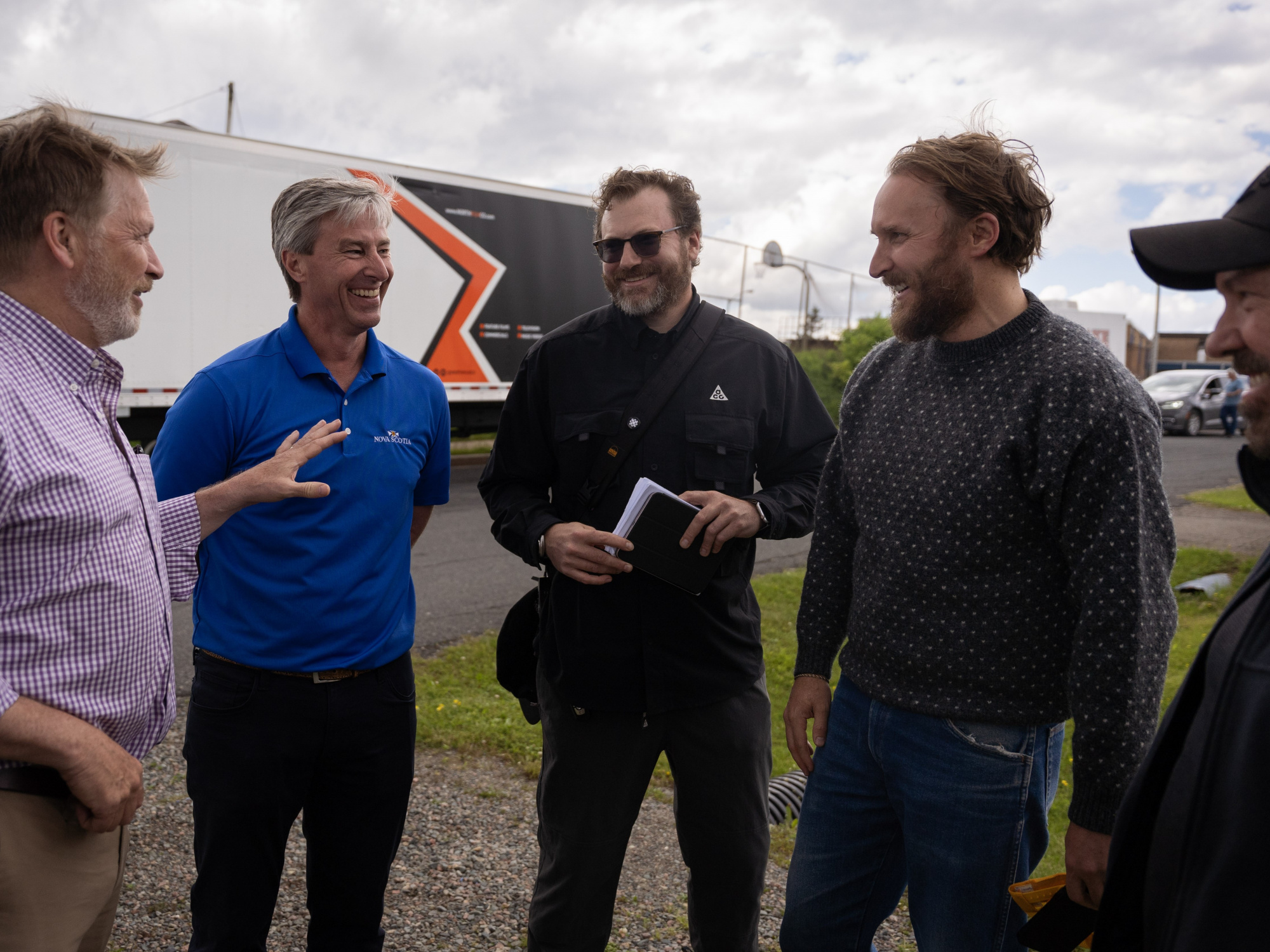 Photo of Premier Tim Houston chatting with four people