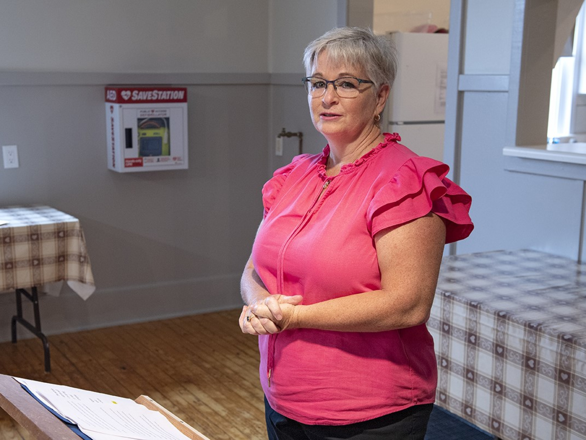 Photo of a woman speaking in a community hall