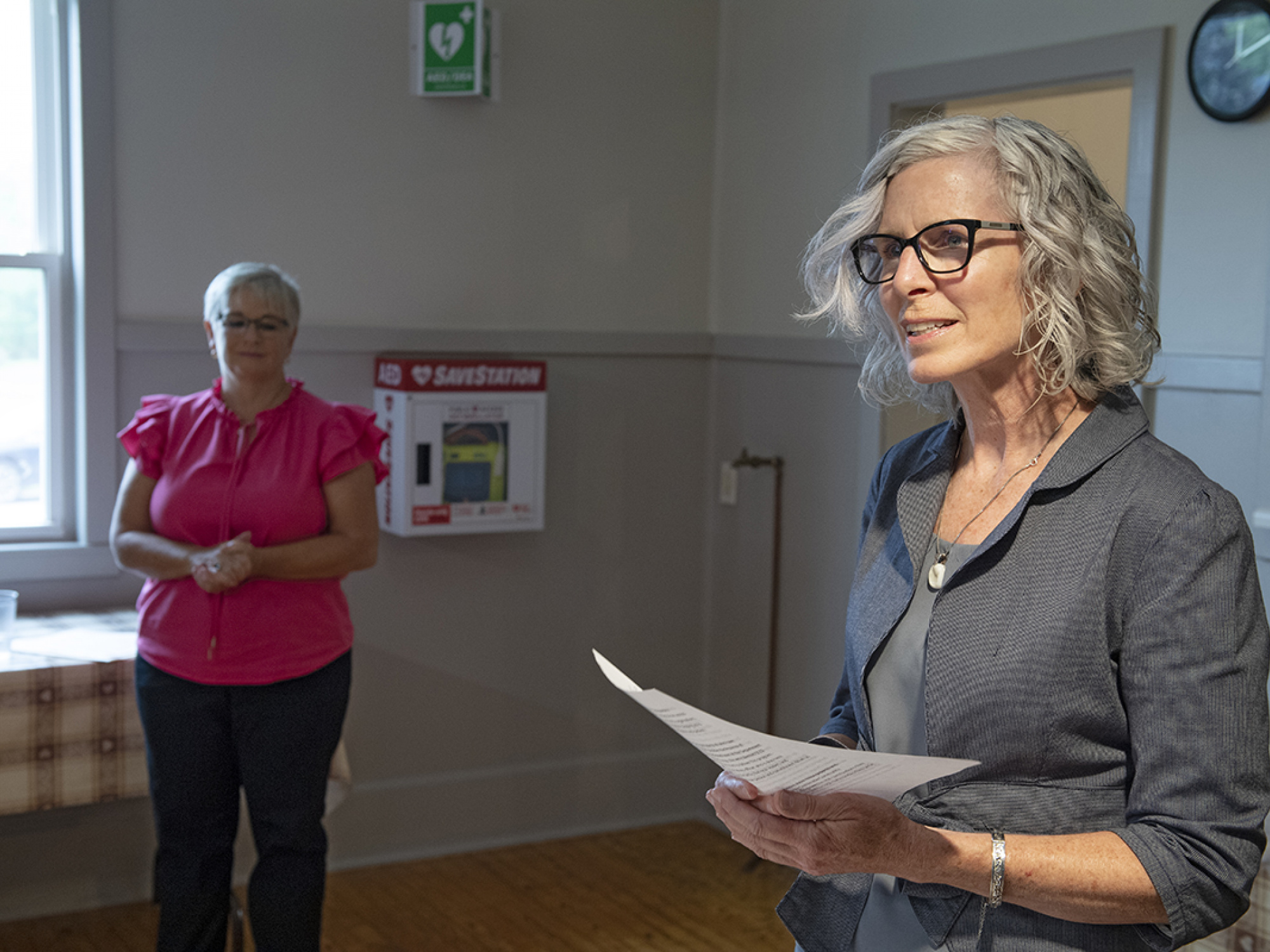 Photo of a woman speaking in a community hall