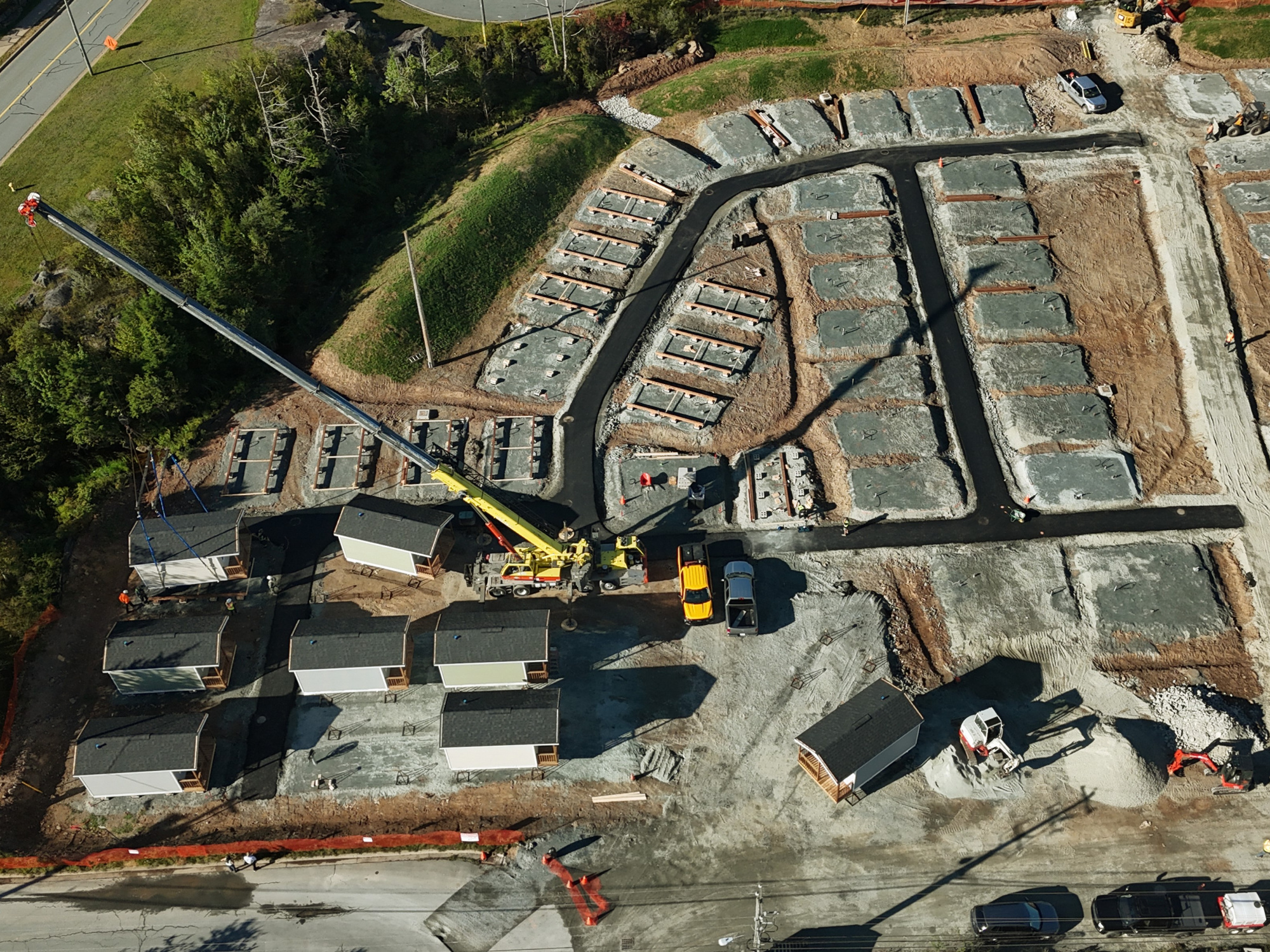 Aerial photo of crane installing tiny homes in Lower Sackville