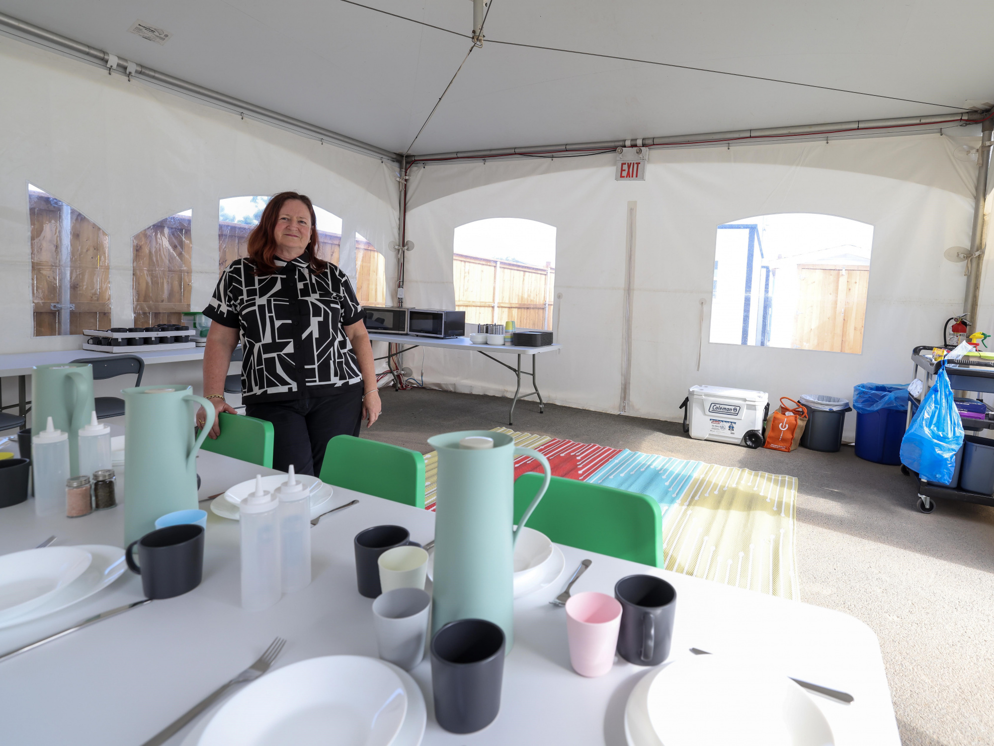 Photo of a woman in a common eating area at a shelter village