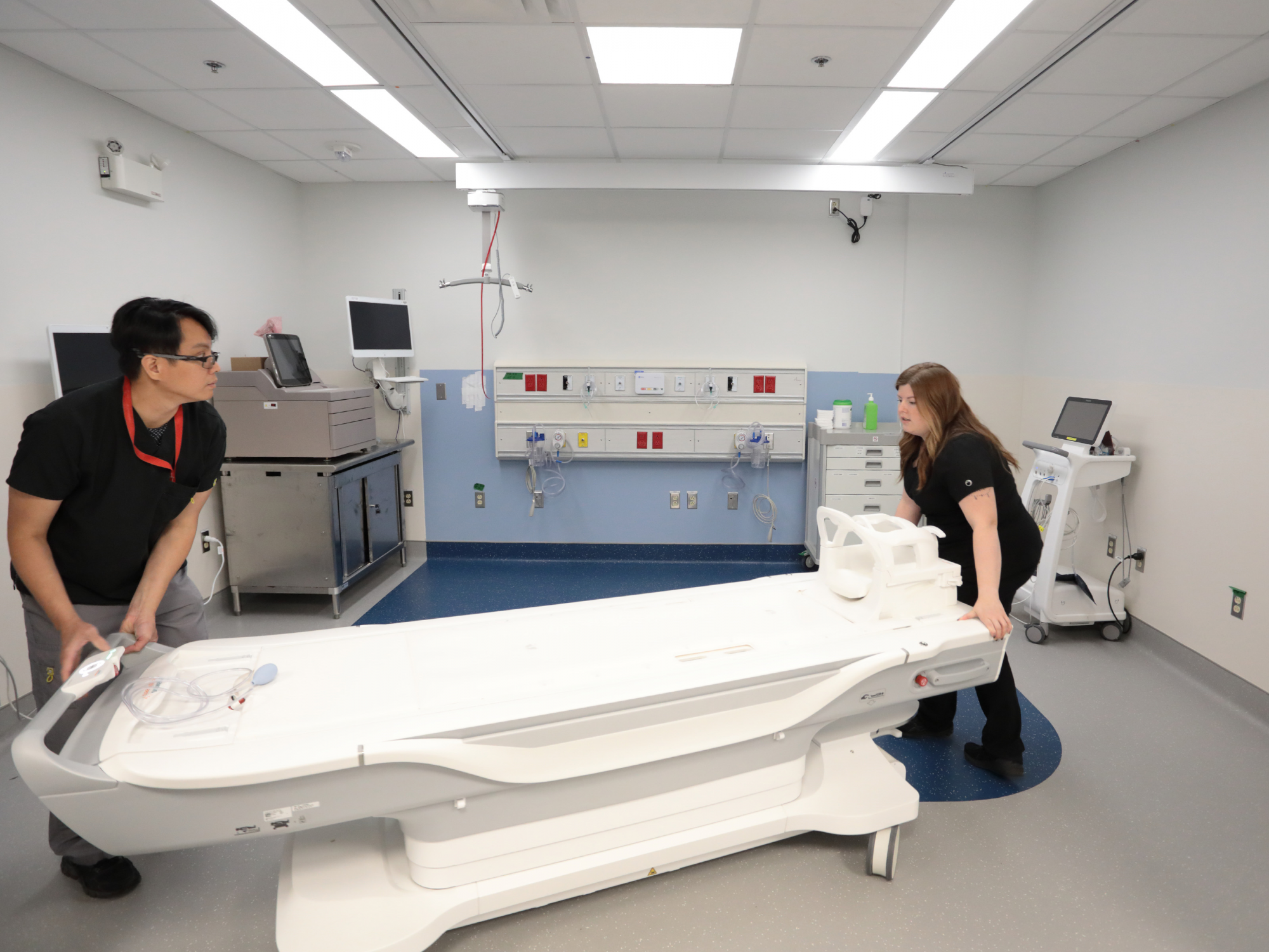 Two MRI technologists prepare a patient to enter the new 1.5T scanner in the new MRI suite at the QEII Health Sciences Centre in Halifax.