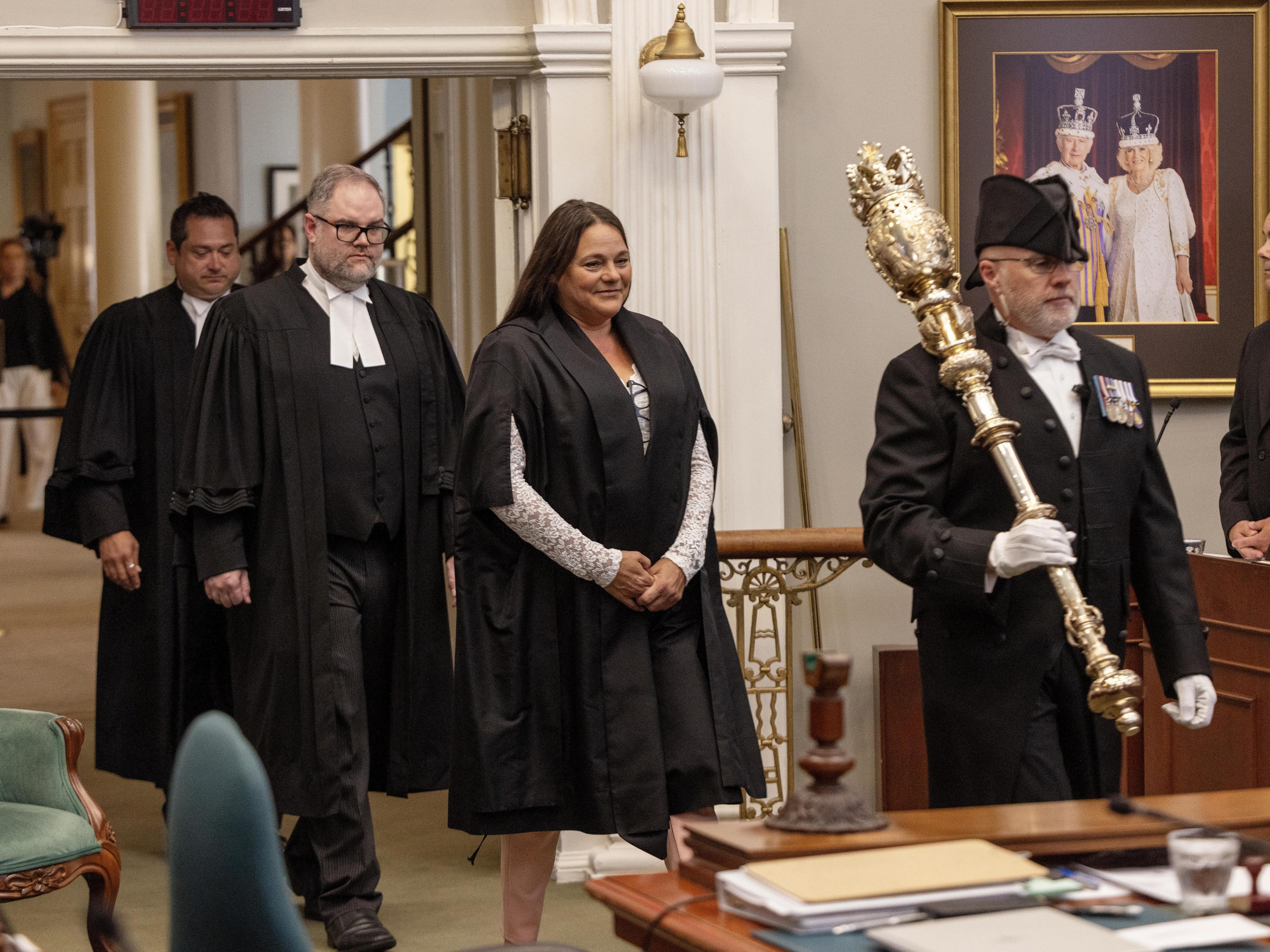 Photo of new Speaker Danielle Barkhouse being escorted in the legislative chamber