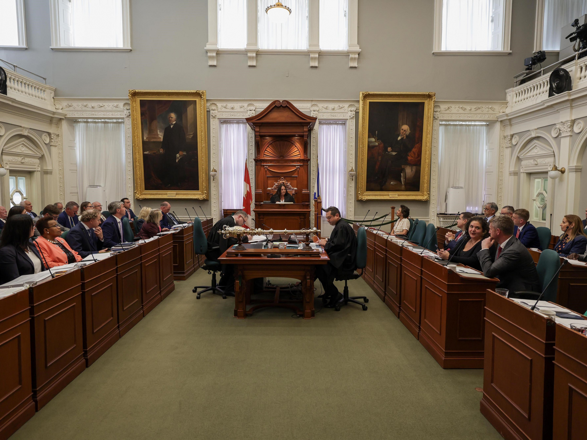 Photo of MLAs and new House Speaker Danielle Barkhouse in the legislative chamber