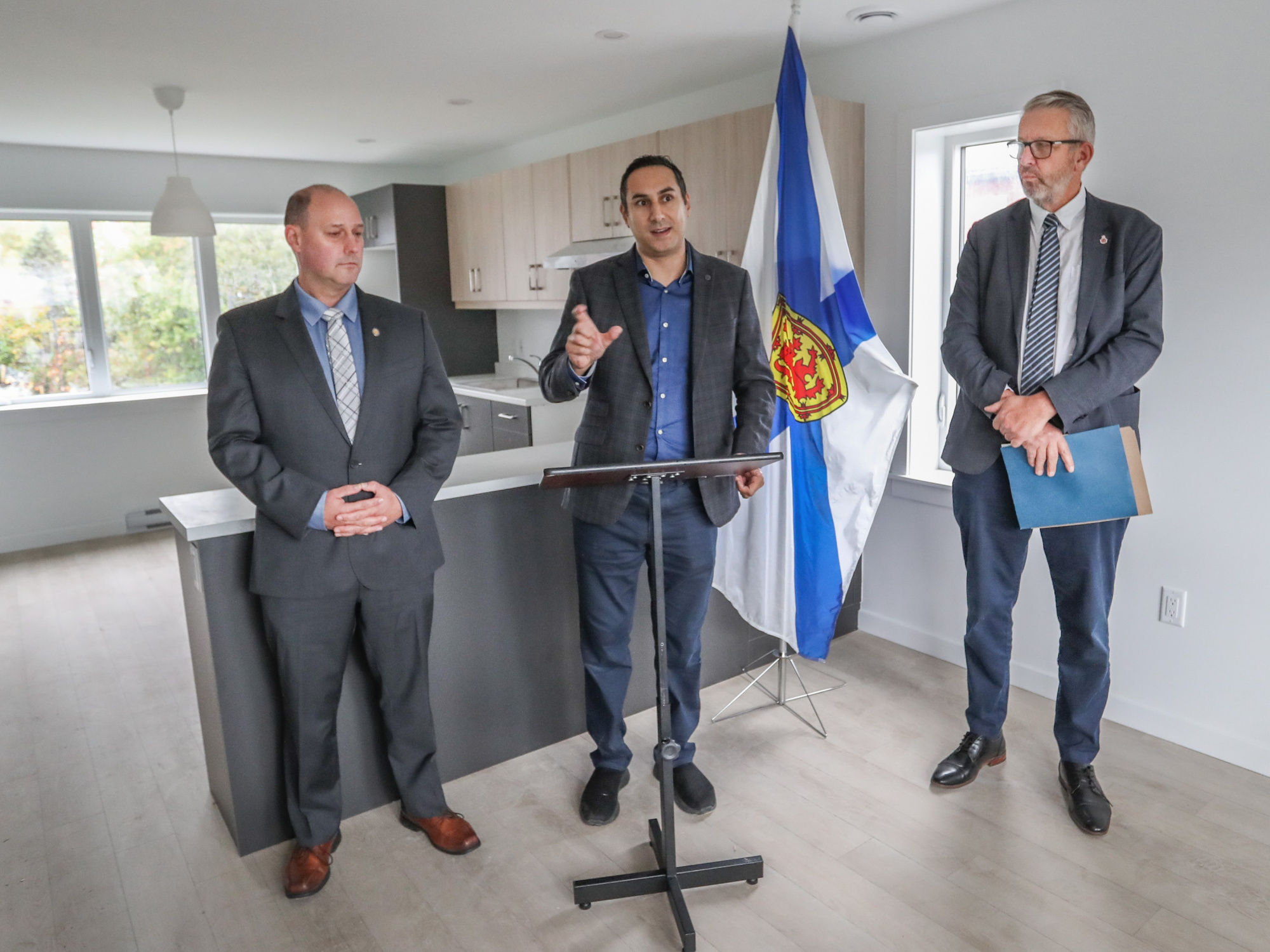 Minister Timothy Halman, Michael Kabalen and Minister John Lohr answer questions ay housing announcement