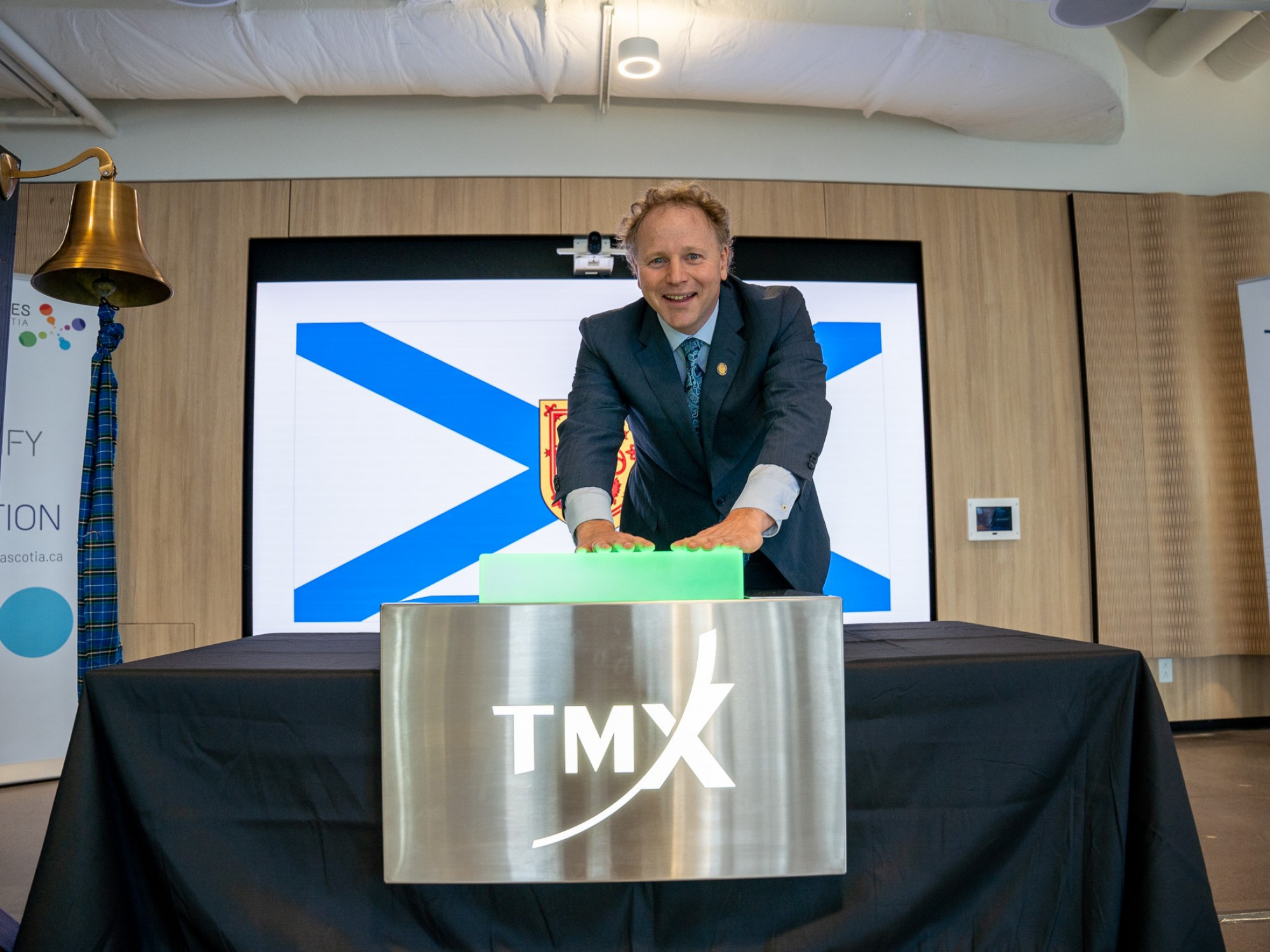 Deputy Premier Alan MacMaster opens the Toronto Stock Exchange from the Health Innovation Hub in Halifax today, October 8. (Province of Nova Scotia)