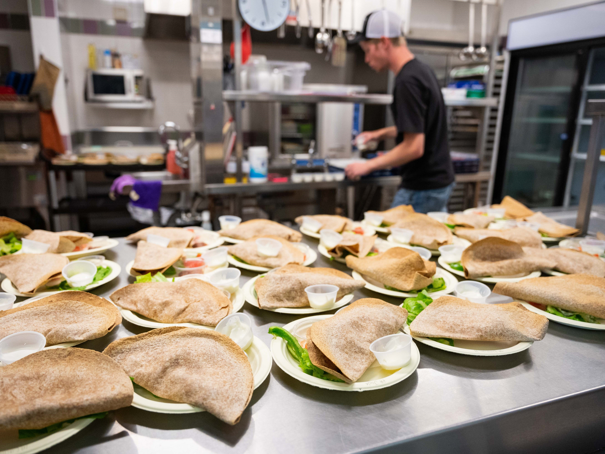 Photo of pitas on plates in a school kitchen