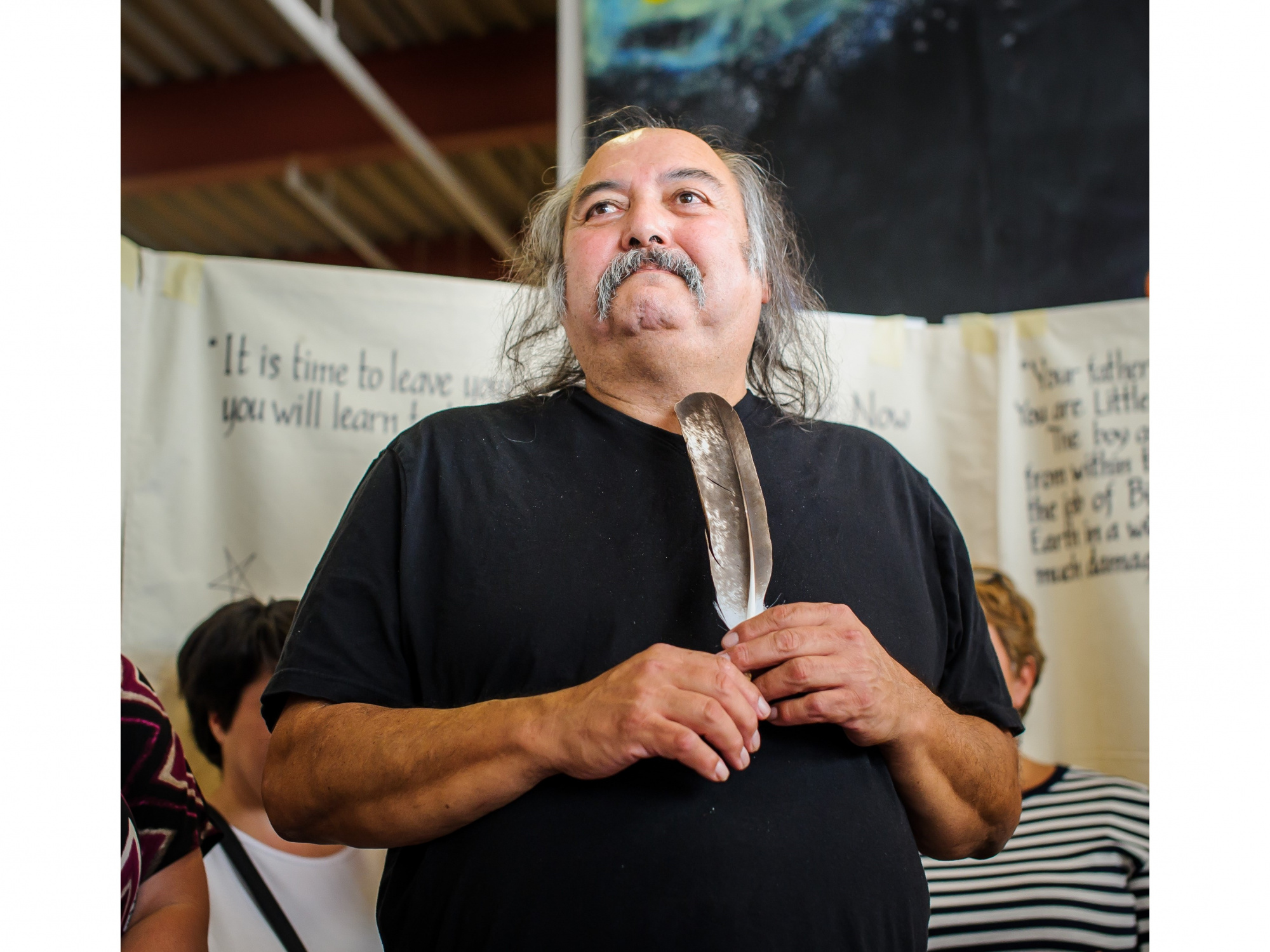 Photo of Alan Syliboy holding a feather