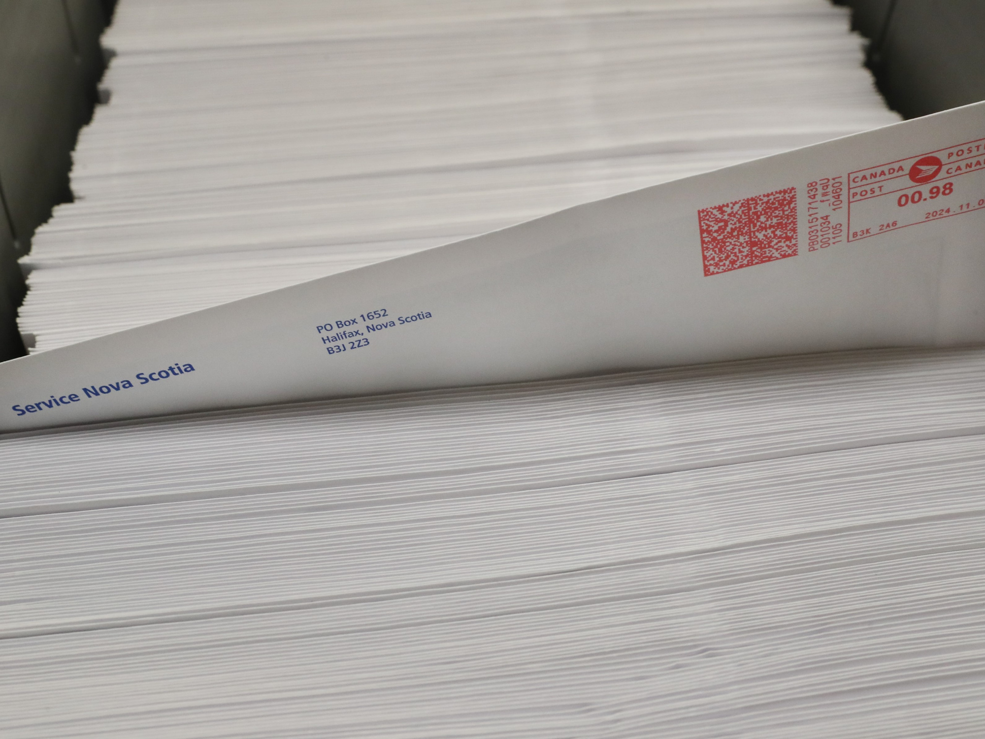 photo of a stack of government mail, with one envelope protruding