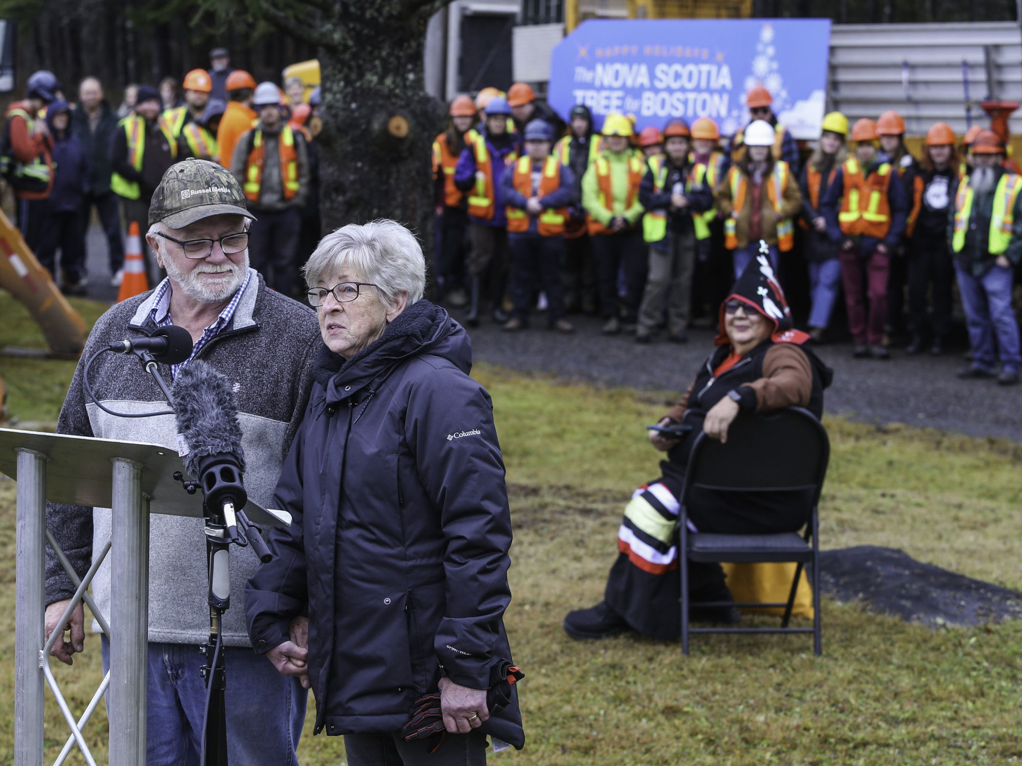 Photo of two people at an outdoor podium 