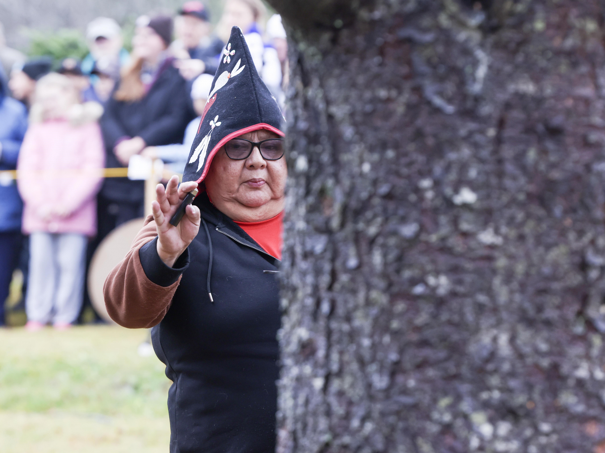 Photo of Marie Pictou, an elder from the Paqtnkek Mi’kmaw First Nation, performs a smudging ceremony over the Tree for Boston