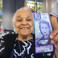 Wanda Robson holding $10 bill