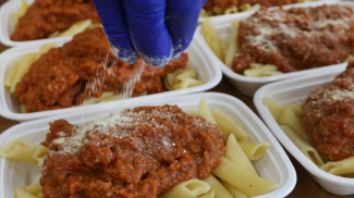 Sprinking cheese on pasta