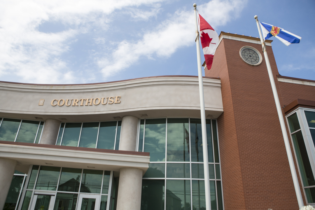 Photo showing the exterior of a Nova Scotia courthouse with a Canadian flag flying