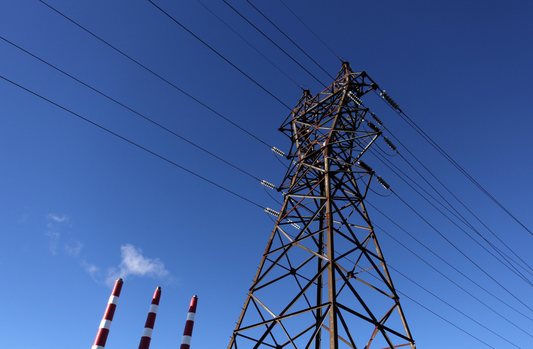 Photo showing power lines and smoke stacks