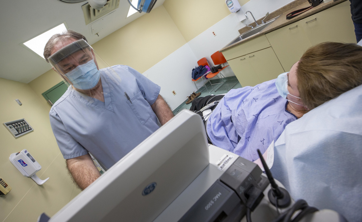 Photo showing an ultrasound technician with a patient