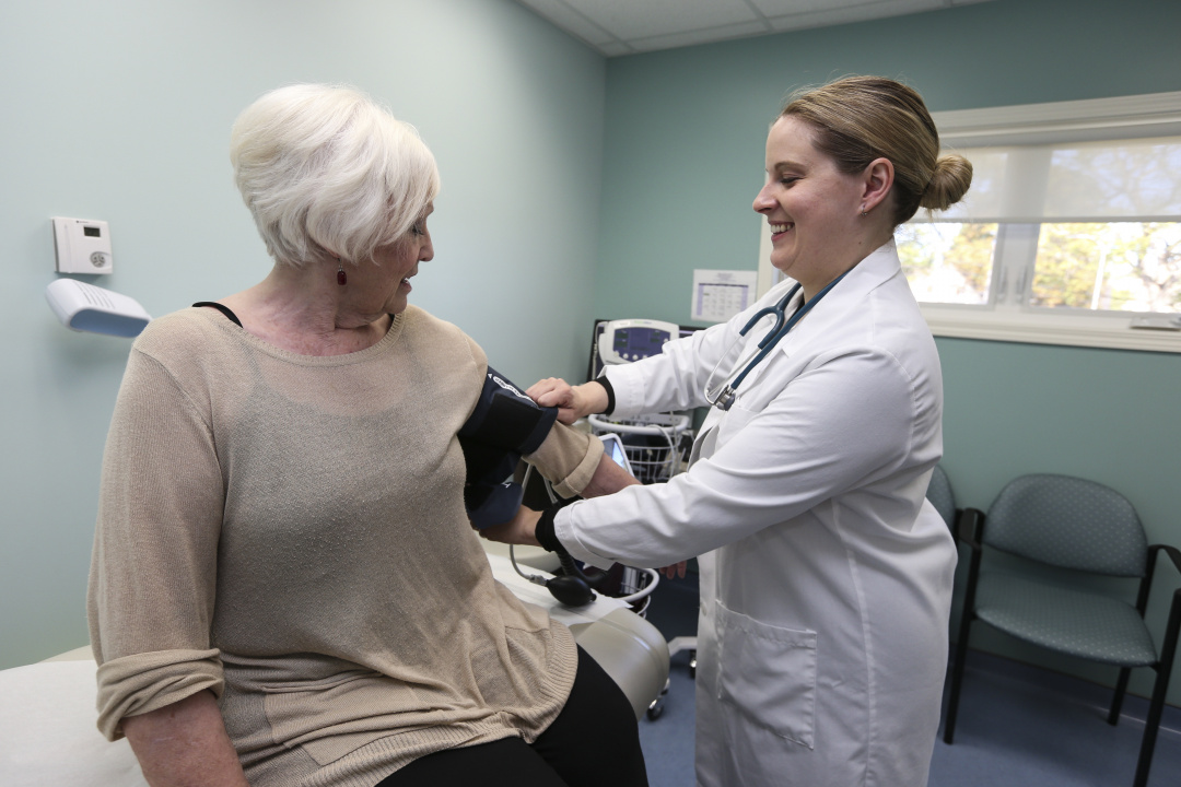 A doctor takes a patient's blood pressure