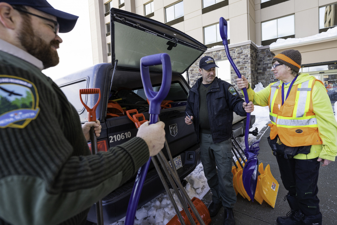 Department of Natural Resources and Renewables staff hand out snow shovels.