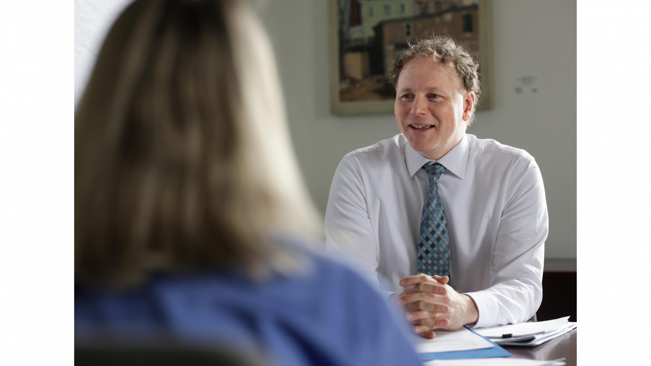 Photo of Finance Minister Allan MacMaster at his desk