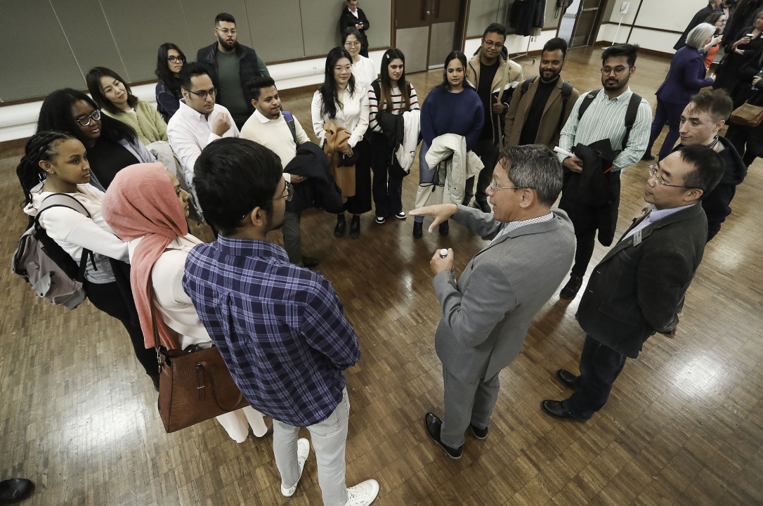 Minister Brian Wong speaks to a group of students