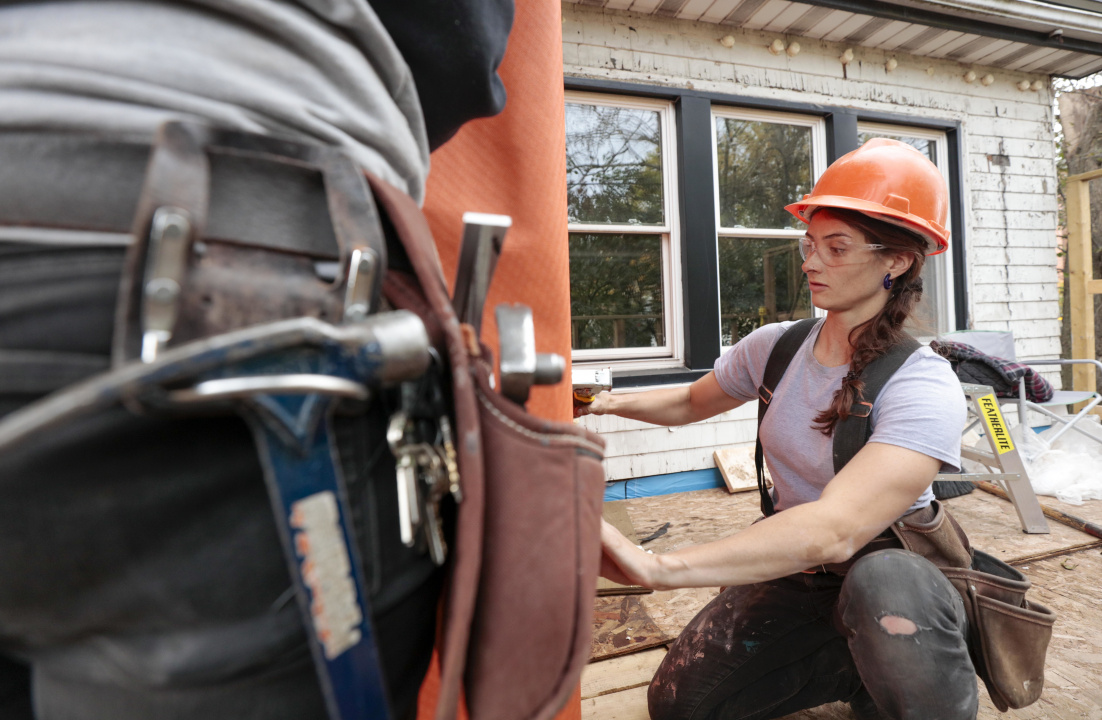 Photo of female apprentice working at construction site