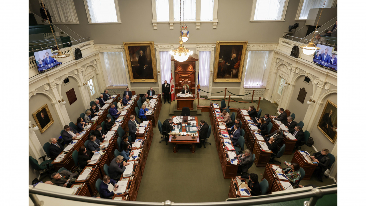 Wide shot of the legislative chamber with Finance and Treasury Board Minister Allan MacMaster delivering his budget address