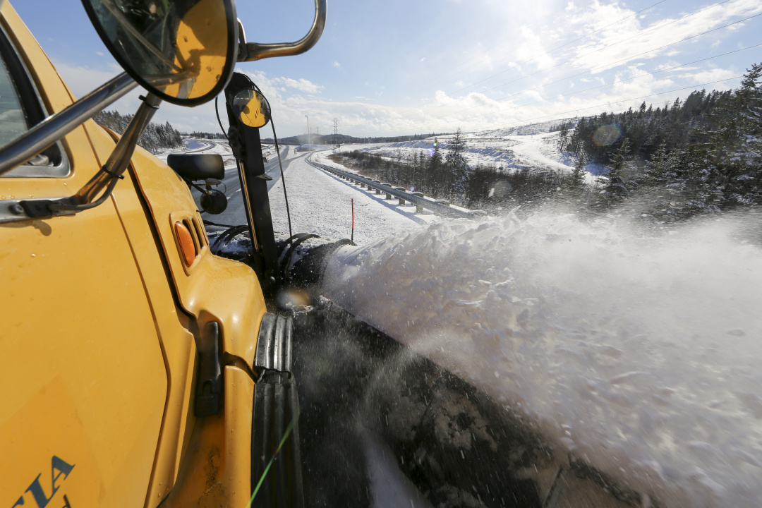 Photo of snowplow and snow spraying up