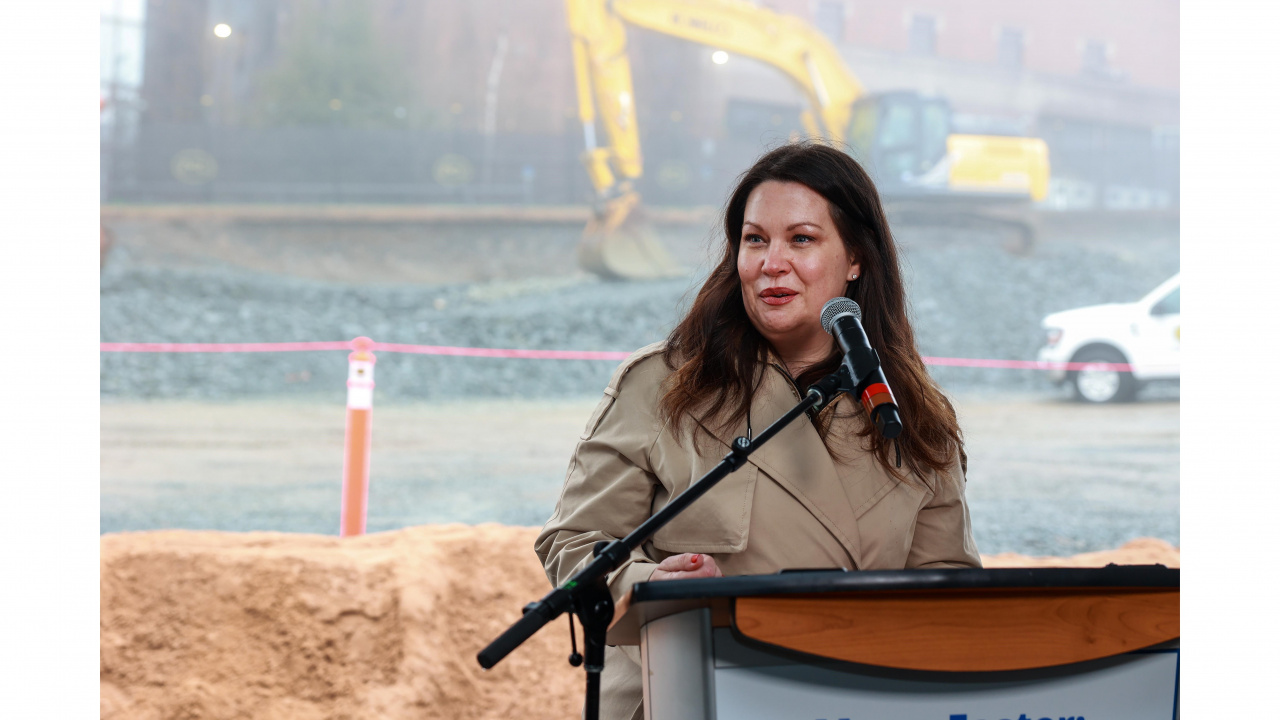 Photo of Dr. Christy Bussey at a podium outdoors