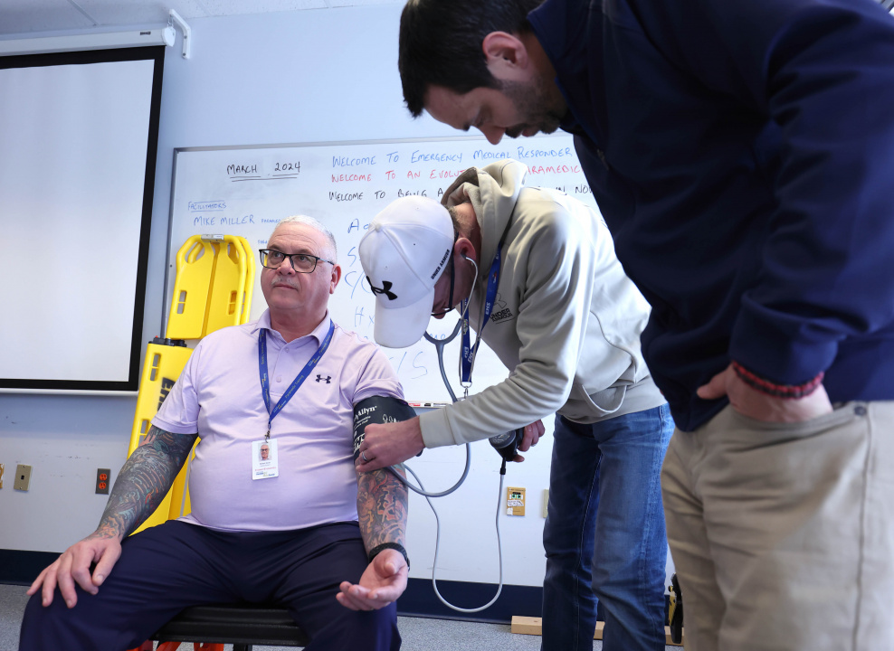 An emergency medical responder learner practises taking blood pressure