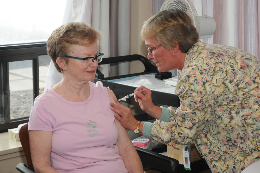 A senior receives her COVID-19 vaccine 