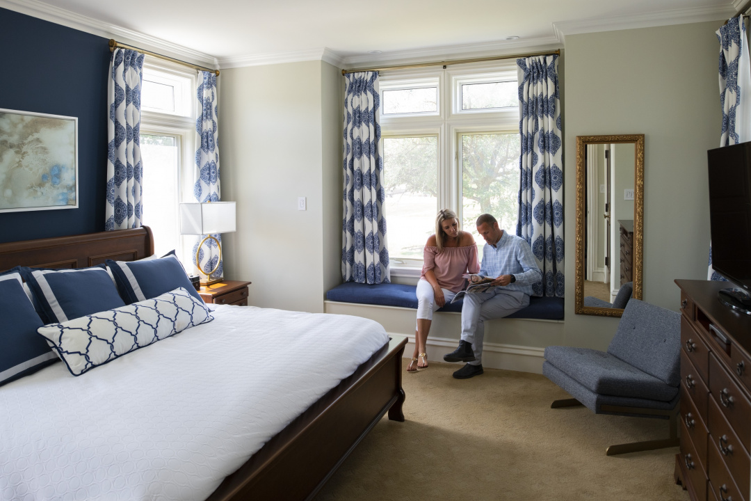 A vacationing couple relaxes in the window seat of a rental unit (Tourism Nova Scotia)