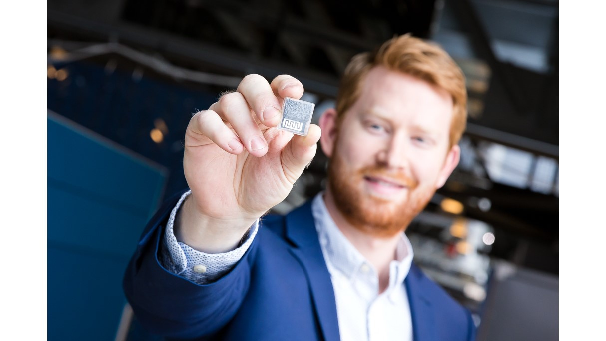 Photo of a man holding up a computer chip